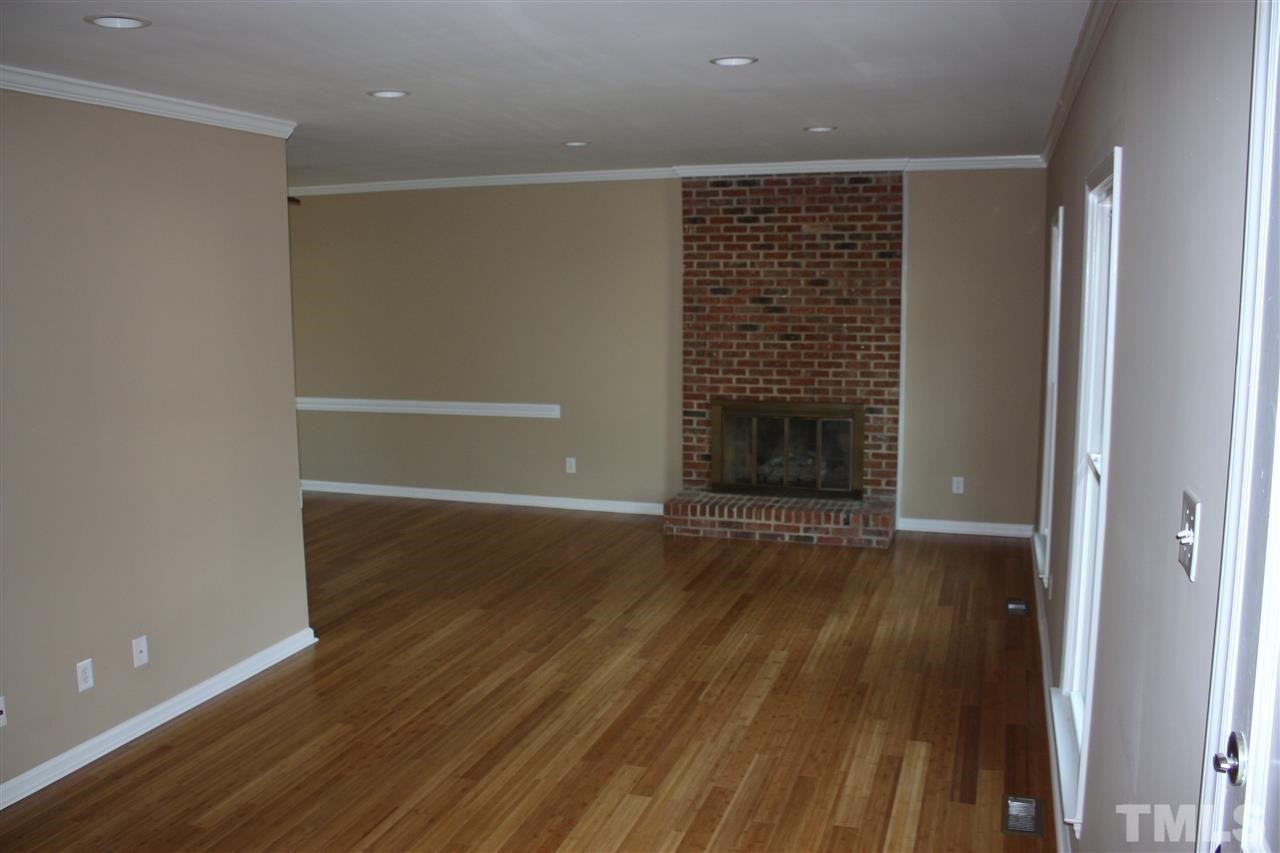 108 Ridgepath Way Cary, NC 27511 - Photo 11 of 20 a view of an empty room with wooden floor and a window
