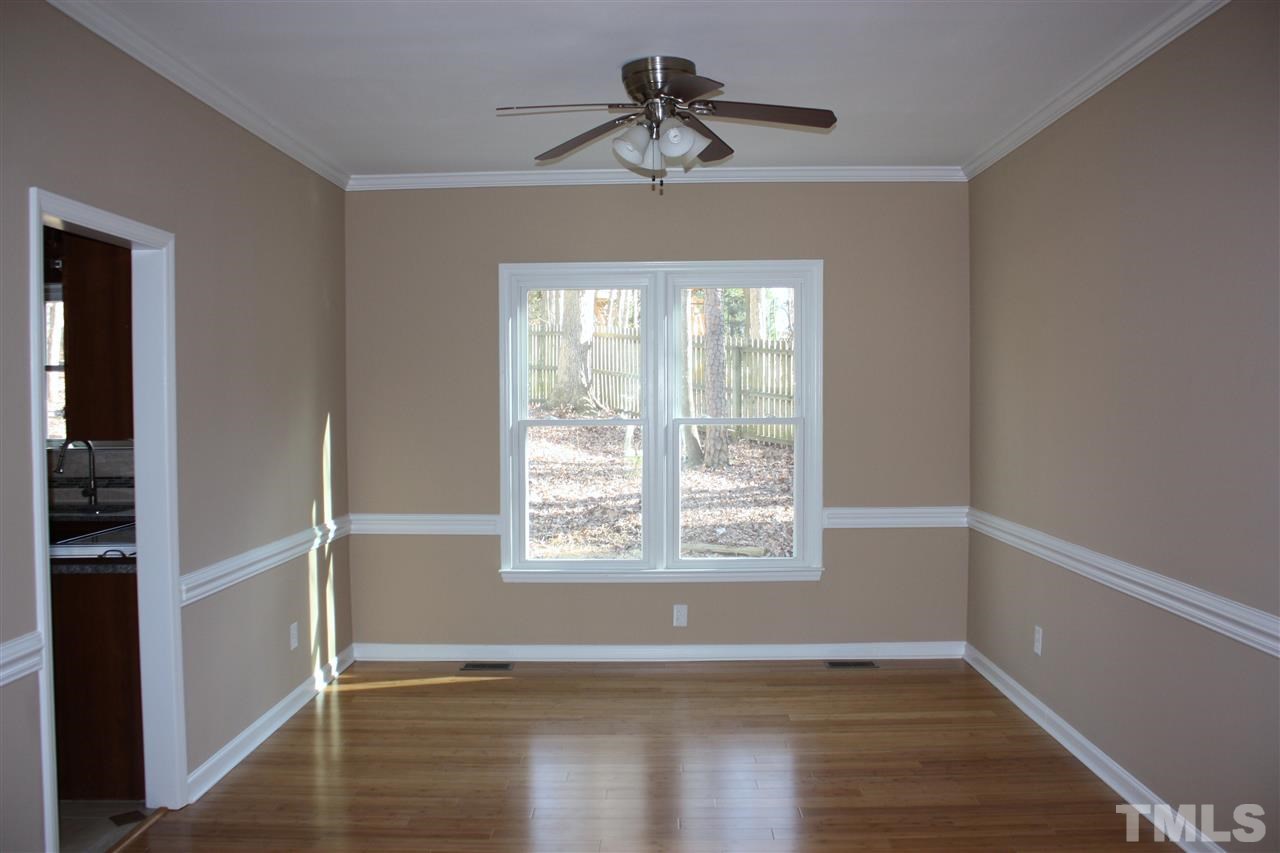 108 Ridgepath Way Cary, NC 27511 - Photo 13 of 20 a view of an empty room with wooden floor and a window