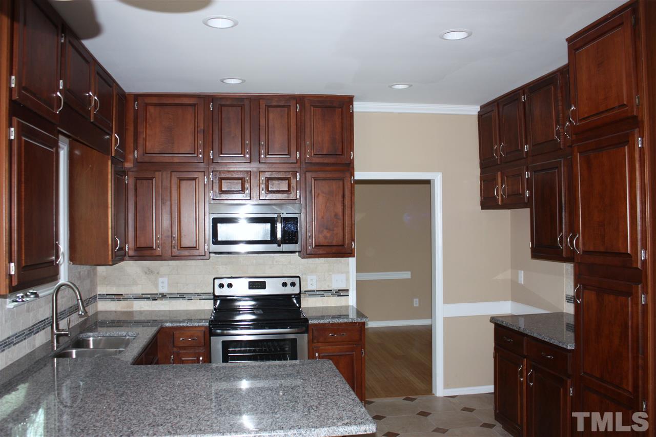 108 Ridgepath Way Cary, NC 27511 - Photo 15 of 20 a kitchen with stainless steel appliances granite countertop a refrigerator and a stove