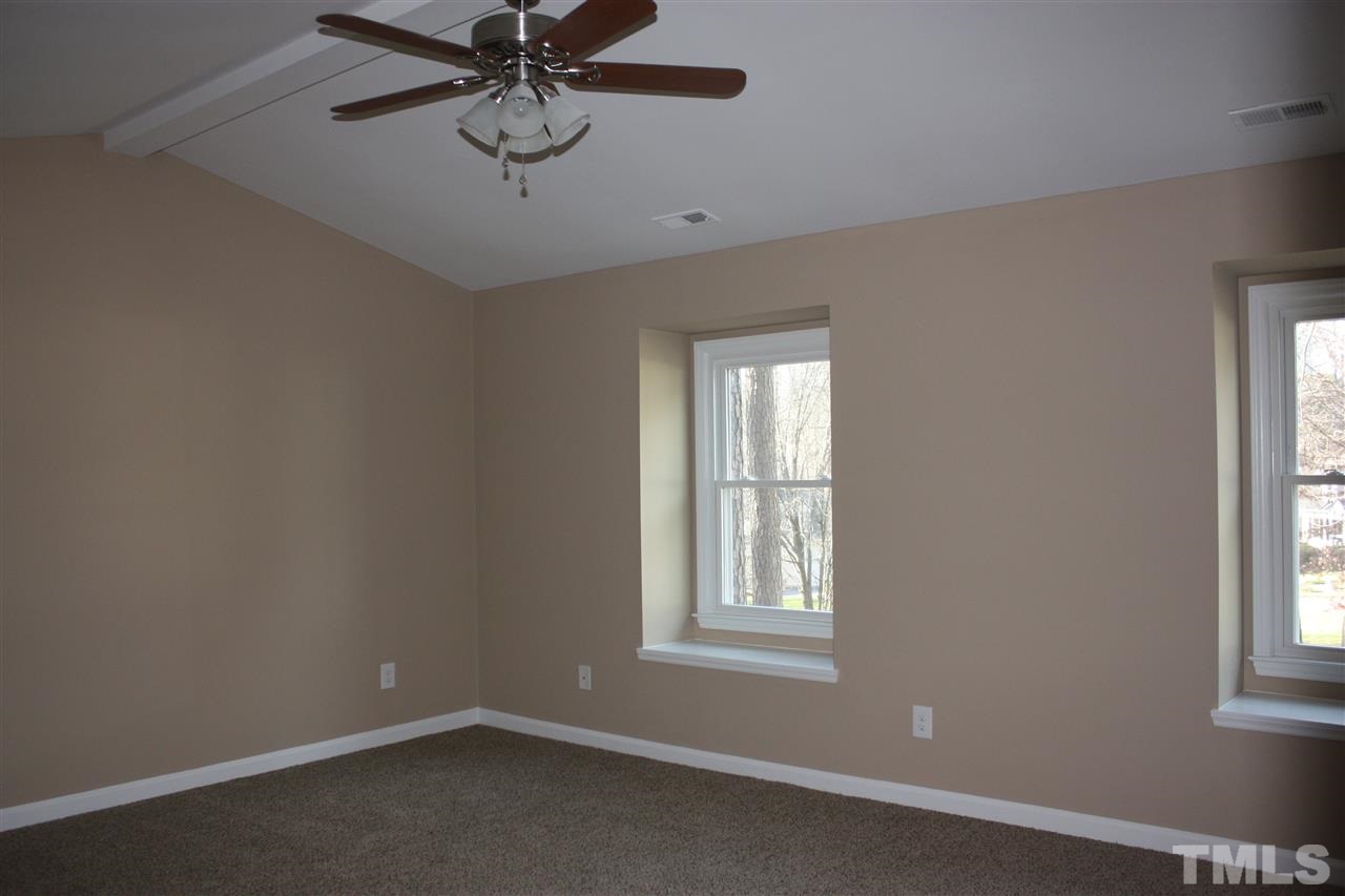 108 Ridgepath Way Cary, NC 27511 - Photo 3 of 20 an empty room with windows and fan