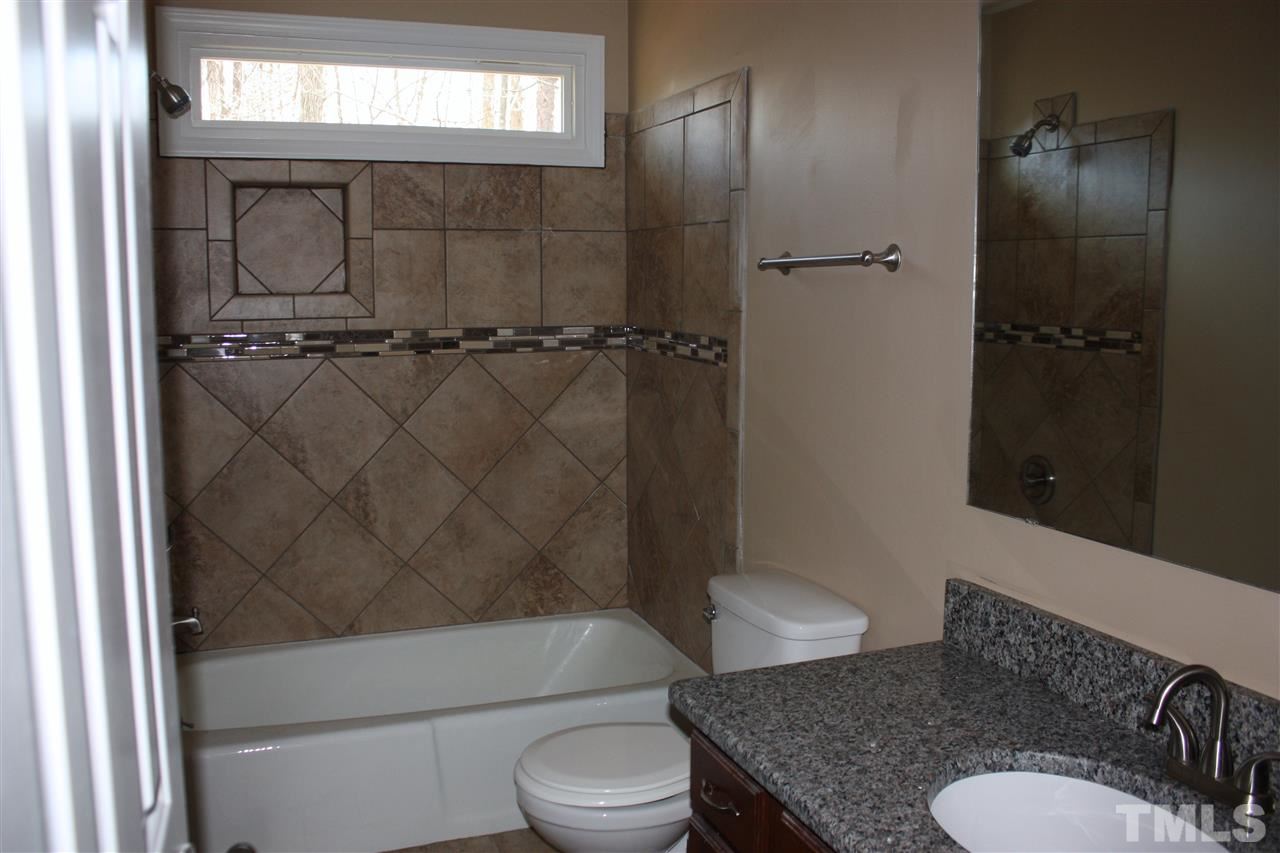 108 Ridgepath Way Cary, NC 27511 - Photo 8 of 20 a bathroom with a granite countertop toilet sink and shower