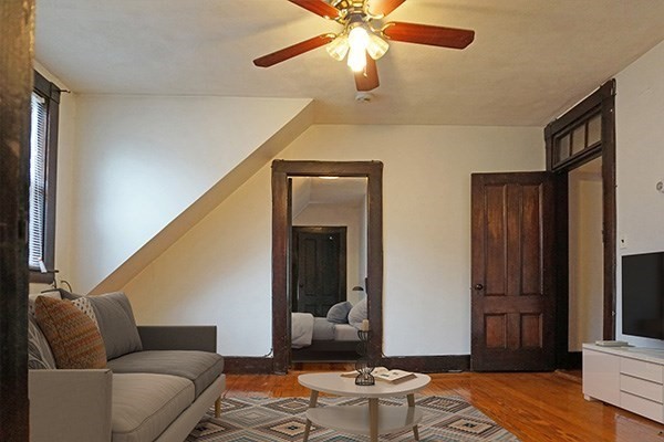 159 Brown Street, Unit 3 Waltham, MA 02453 - Photo 3 of 10 a living room with furniture and a flat screen tv