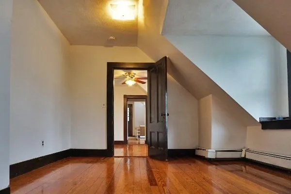 a view of a room with wooden floor and stairs