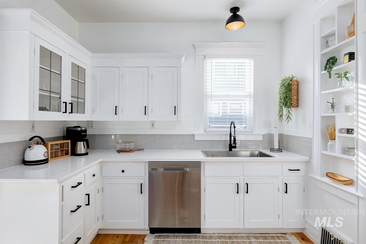 1904 North 16th Street Boise, ID 83702 - Photo 17 of 28 Kitchen featuring white cabinetry, stainless steel dishwasher, glass fronted cabinets, open shelves, and backsplash