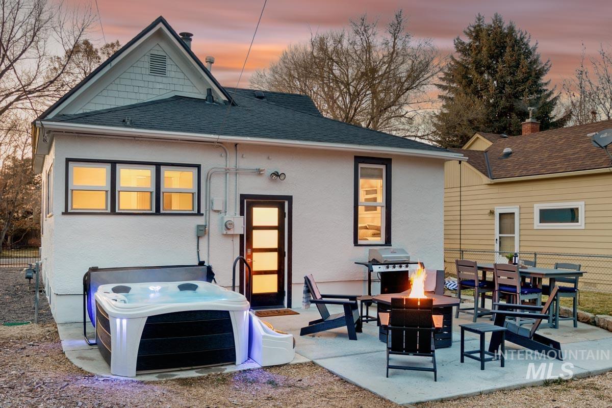 1904 North 16th Street Boise, ID 83702 - Photo 27 of 28 Rear view of house with a shingled roof, a patio area, a fire pit, outdoor dining area, and stucco siding