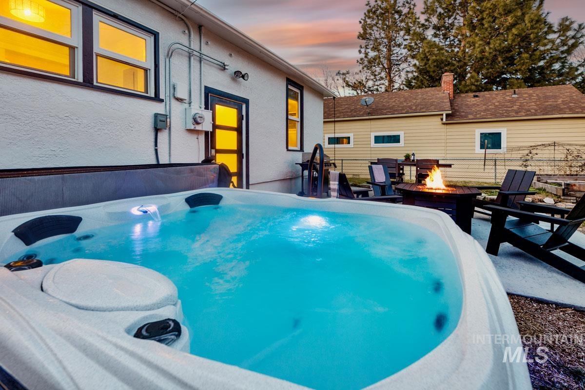 1904 North 16th Street Boise, ID 83702 - Photo 8 of 28 Pool at dusk featuring an outdoor fire pit, a patio area, and a hot tub
