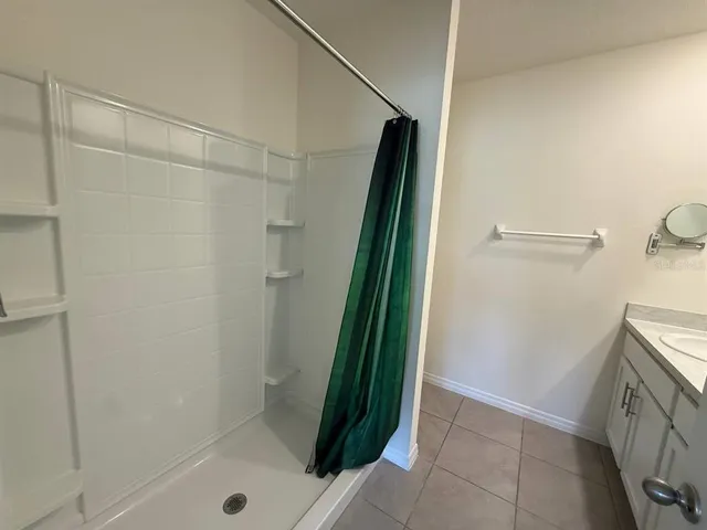 a bathroom with a shower and a sink