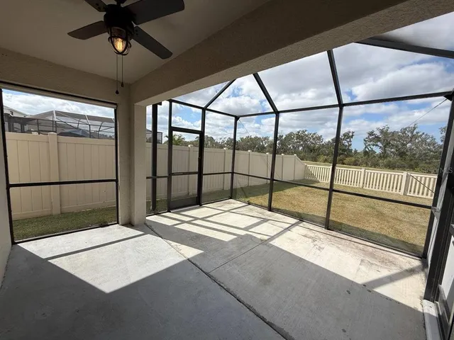 a bedroom with a large bed and a large window