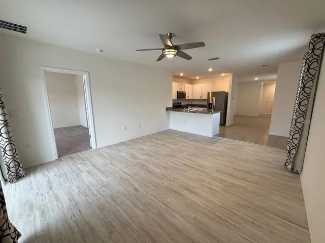a view of a kitchen with a sink and cabinets