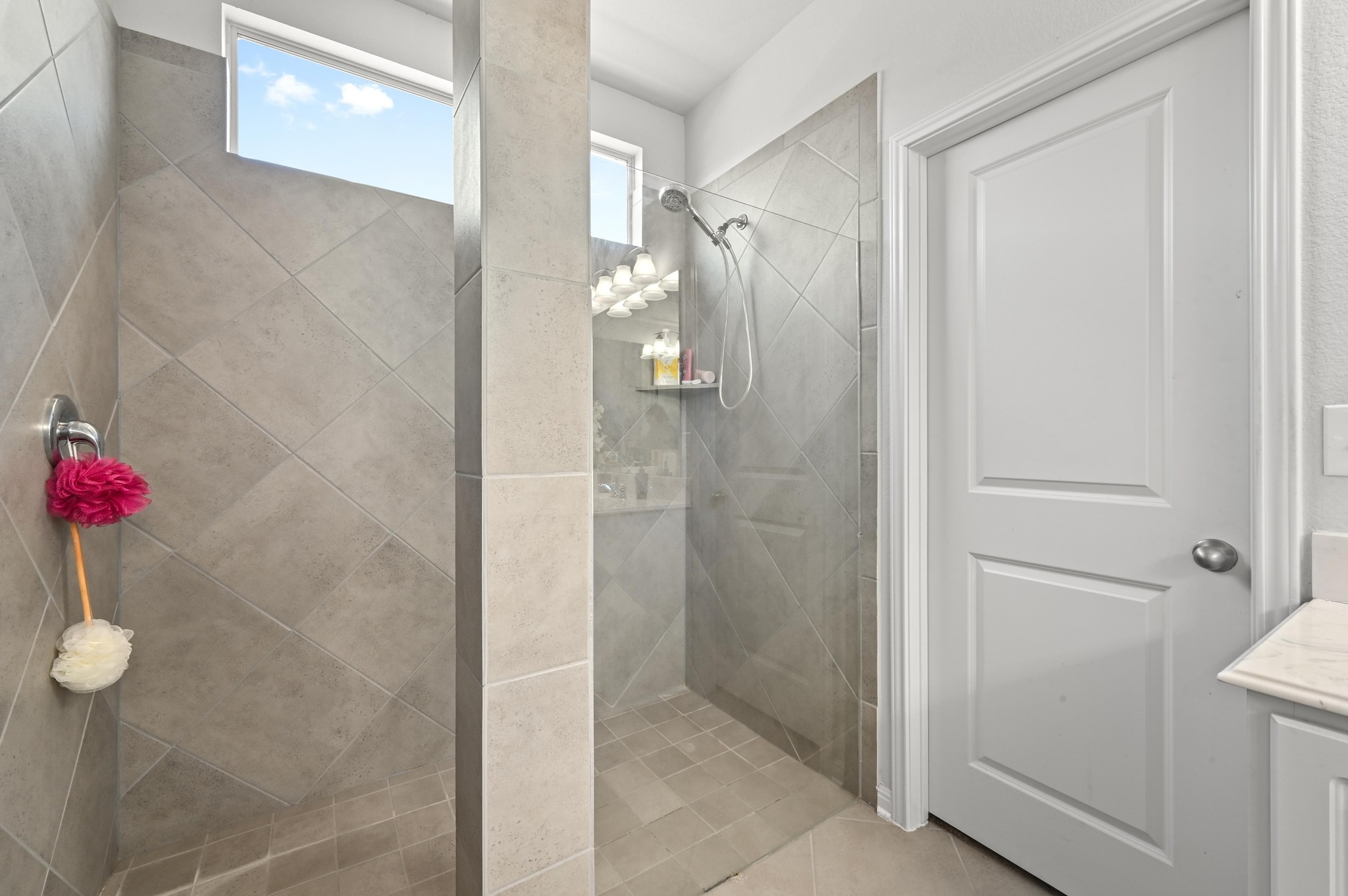 1480 Sanders Kyle, TX 78640 - Photo 15 of 27 There's also a standout walk-in shower with gorgeous tile surround and frameless glass splash guard.