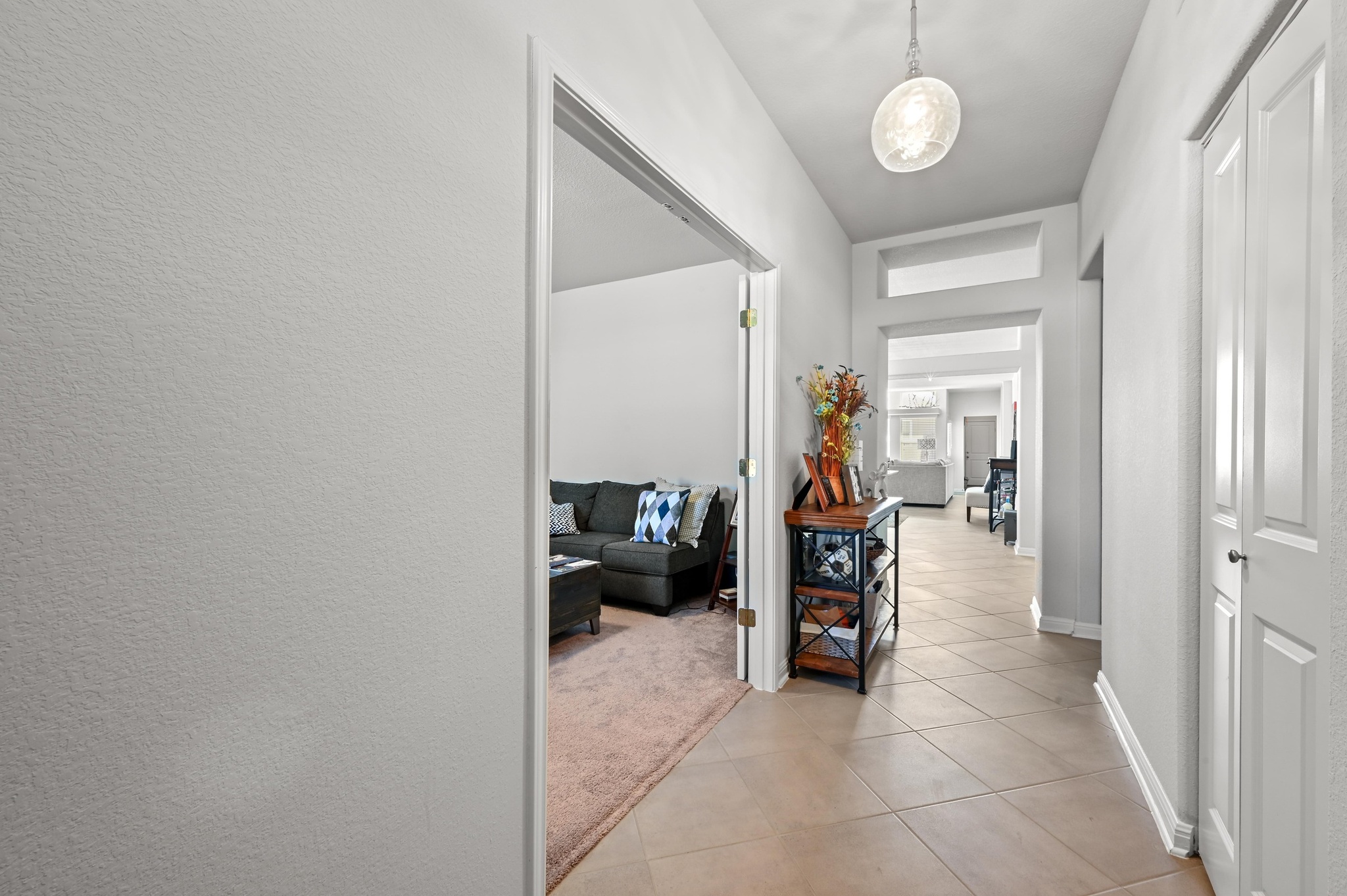 1480 Sanders Kyle, TX 78640 - Photo 8 of 27 Inside, a welcoming foyer passes a dedicated office with French doors and opens to a spacious kitchen, dining, and living area designed for everyday comfort.