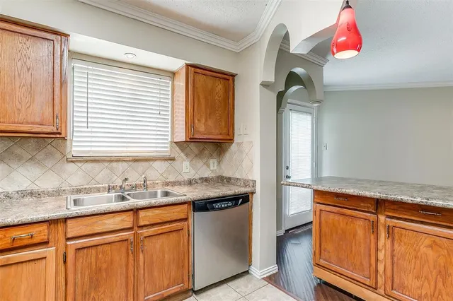 a kitchen with stainless steel appliances granite countertop a sink and a window