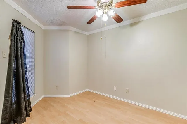 an empty room with a chandelier fan