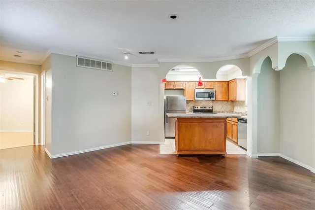 a view of a kitchen cabinets a sink and a wooden floor