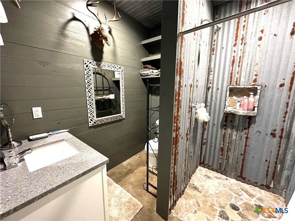 A Juan Antonio Road Victoria, TX 77904 - Photo 8 of 14 a bathroom with a granite countertop sink a mirror and vanity