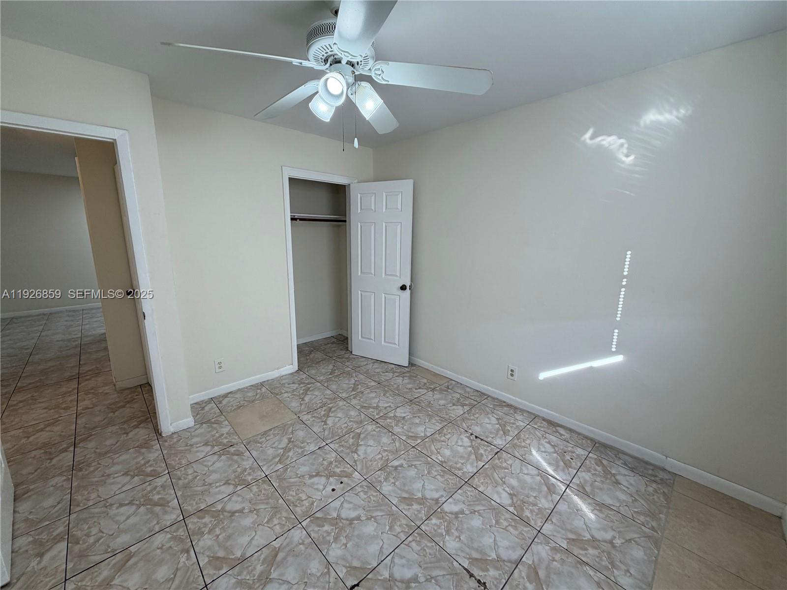 4801 Southwest 18th Street, Unit 3 West Park, FL 33023 - Photo 17 of 22 an empty room with a ceiling fan and a bathroom