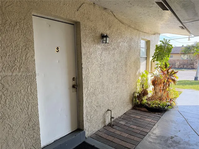 a view of a street with cars parked