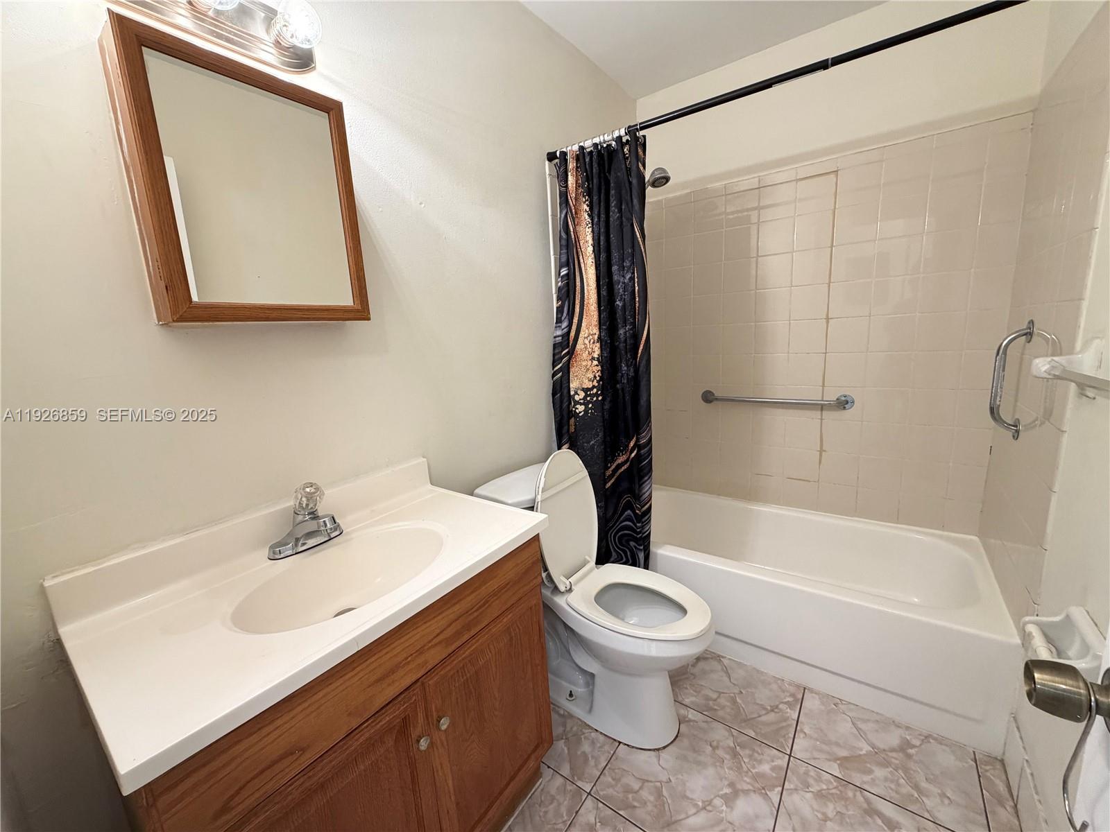 4801 Southwest 18th Street, Unit 3 West Park, FL 33023 - Photo 7 of 22 a bathroom with a sink toilet and shower