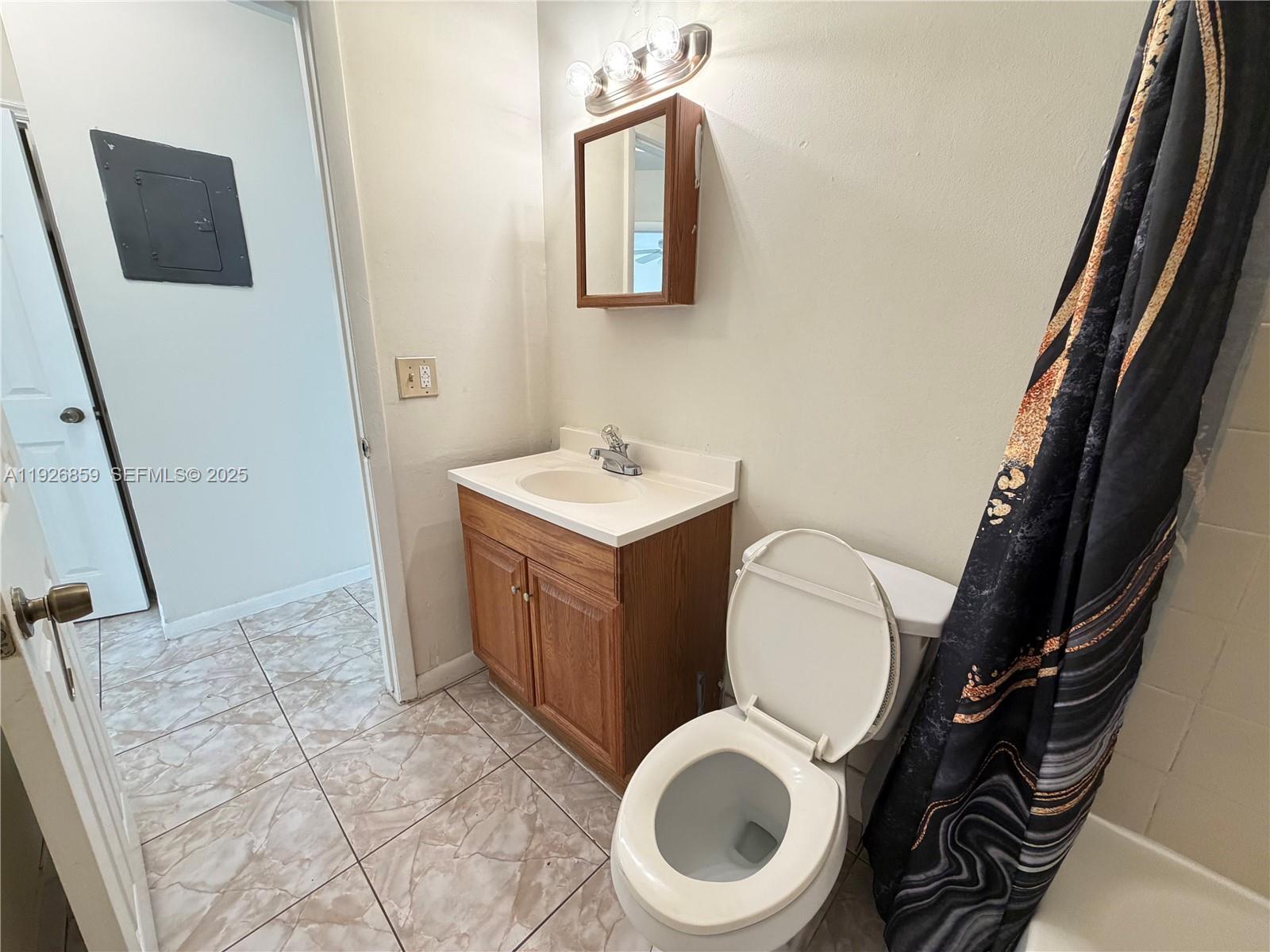 4801 Southwest 18th Street, Unit 3 West Park, FL 33023 - Photo 8 of 22 a bathroom with a toilet a sink and mirror