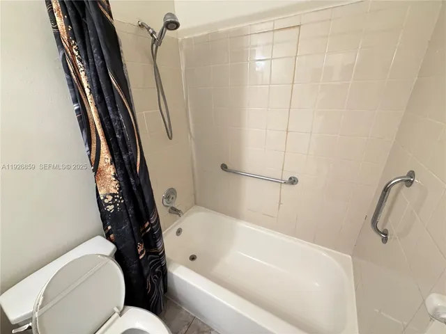 a bathroom with a toilet and a tub