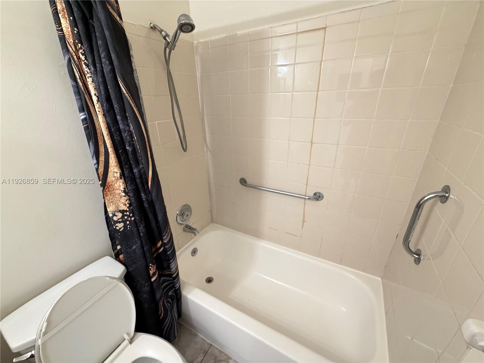 4801 Southwest 18th Street, Unit 3 West Park, FL 33023 - Photo 9 of 22 a bathroom with a toilet and a tub