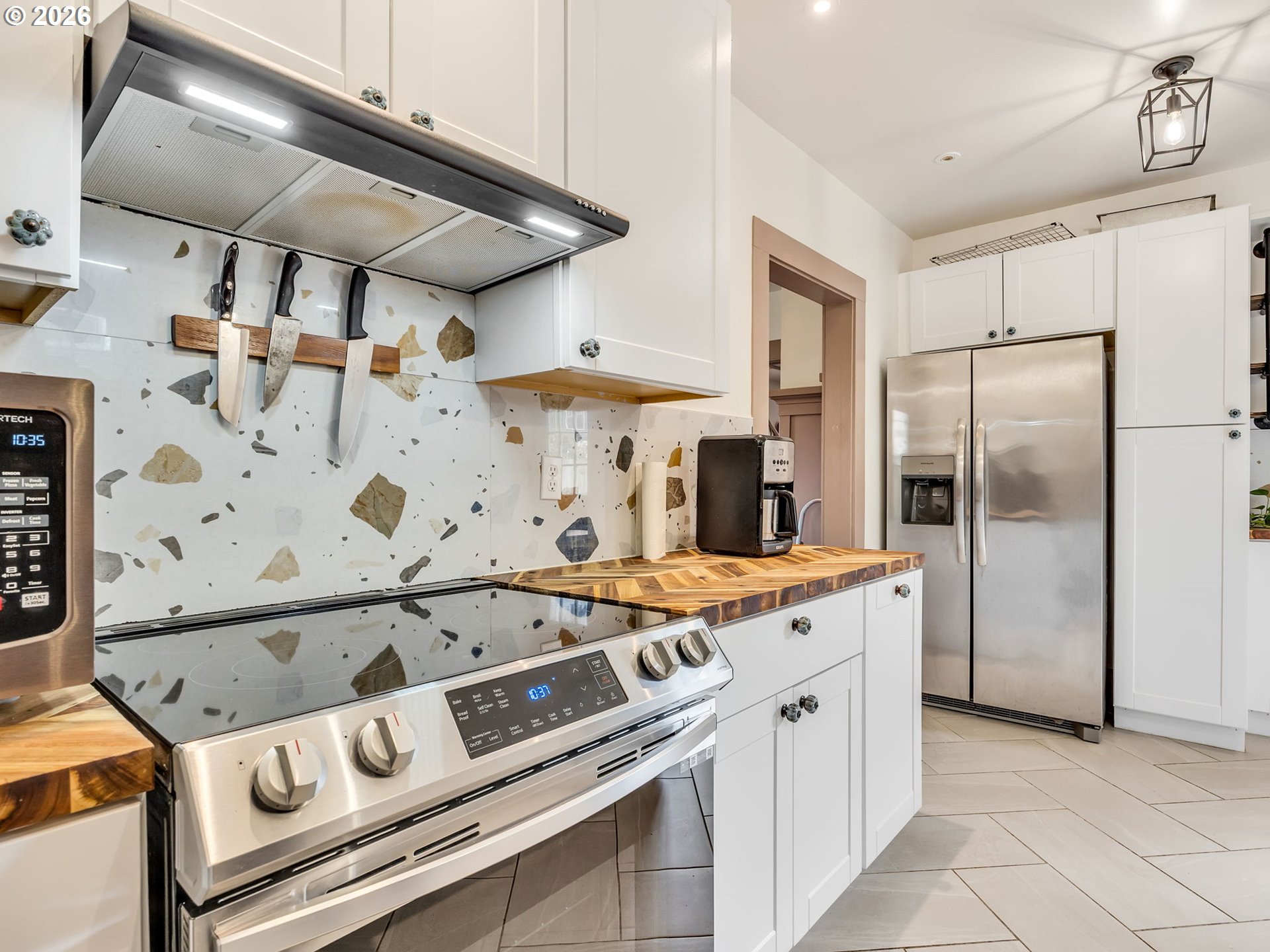 933 8th Street Astoria, OR 97103 - Photo 11 of 31 a kitchen with a stove and a refrigerator