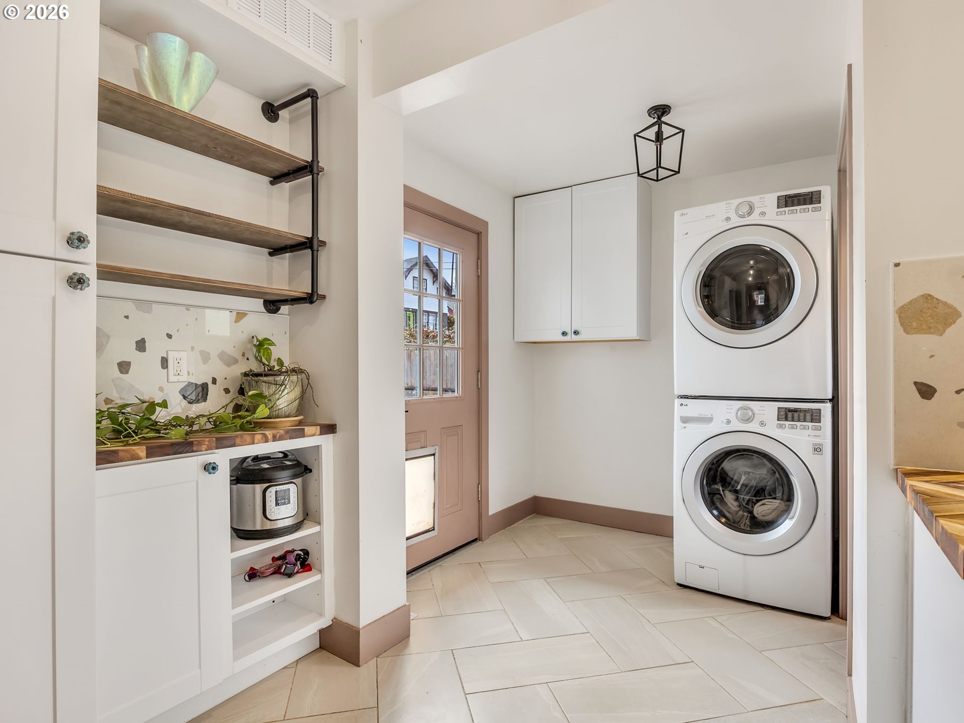 933 8th Street Astoria, OR 97103 - Photo 13 of 31 a view of a storage and utility room with washer and dryer