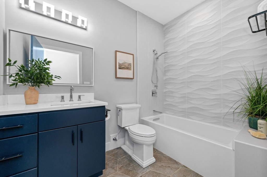 61 Paul Revere Road, Unit 2 Arlington, MA 02476 - Photo 11 of 33 a bathroom with a sink toilet and shower