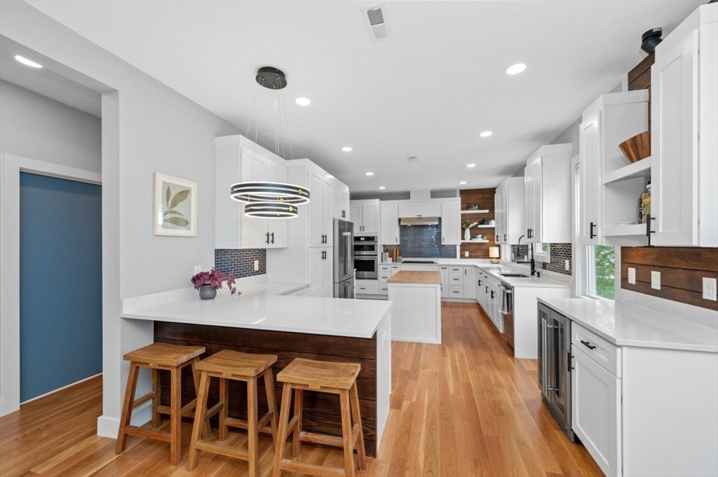 61 Paul Revere Road, Unit 2 Arlington, MA 02476 - Photo 16 of 33 a living room with stainless steel appliances kitchen island granite countertop furniture and wooden floor