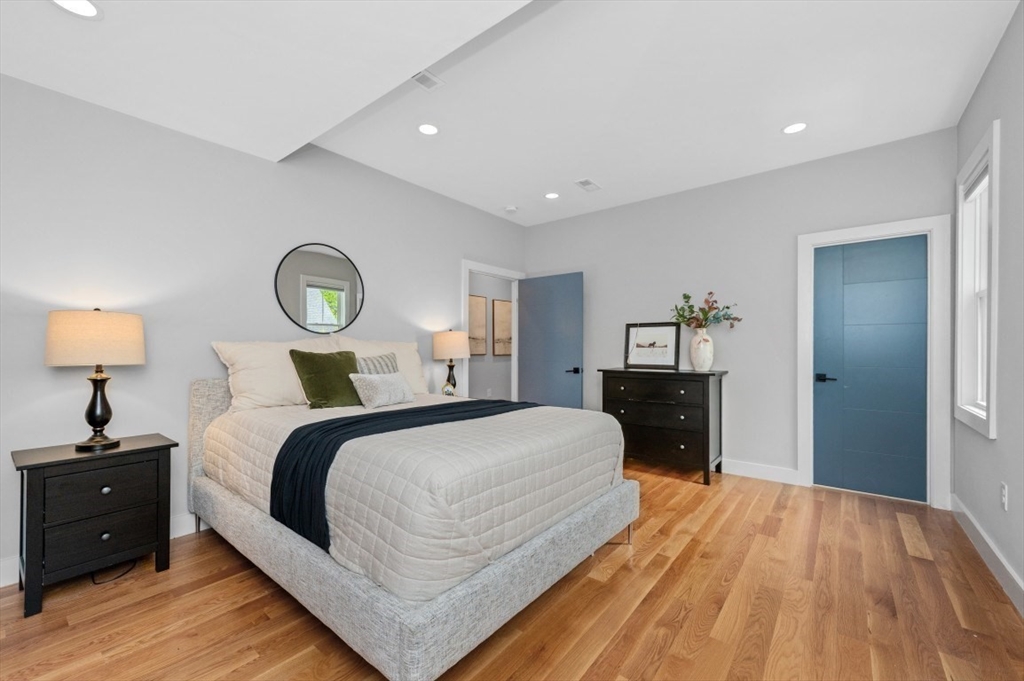 61 Paul Revere Road, Unit 2 Arlington, MA 02476 - Photo 17 of 33 a bedroom with a bed and wooden floor
