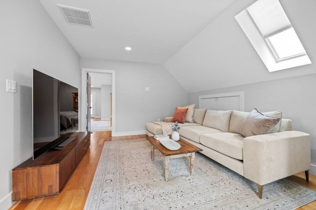 61 Paul Revere Road, Unit 2 Arlington, MA 02476 - Photo 22 of 33 a living room with furniture and a flat screen tv