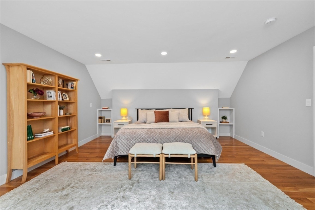 61 Paul Revere Road, Unit 2 Arlington, MA 02476 - Photo 24 of 33 a bedroom with a bed and a bookshelf