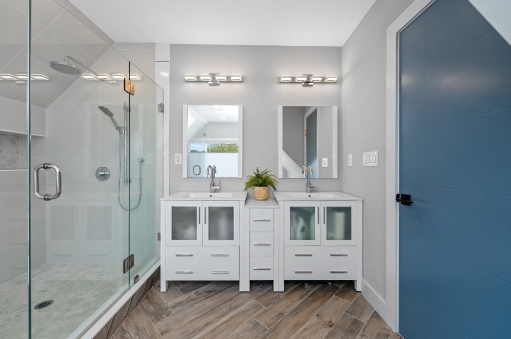 61 Paul Revere Road, Unit 2 Arlington, MA 02476 - Photo 26 of 33 a view of bathroom with double vanity mirror and window