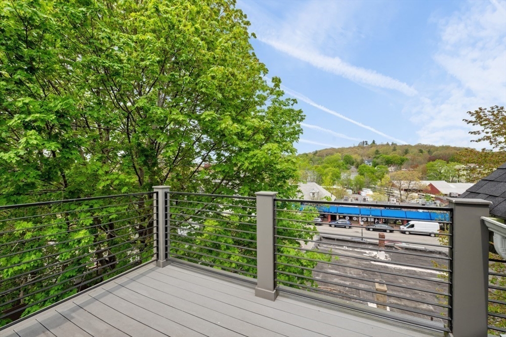 61 Paul Revere Road, Unit 2 Arlington, MA 02476 - Photo 30 of 33 a view of a balcony with wooden floor