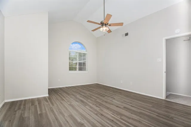 wooden floor in an empty room with a window