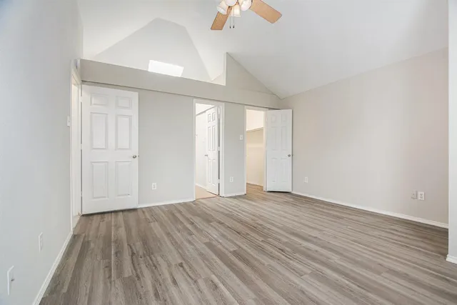 a view of an empty room with wooden floor