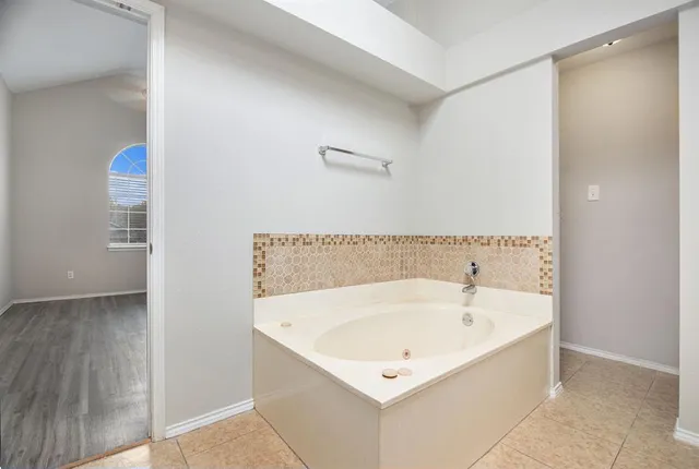 a white bath tub sitting in a bathroom