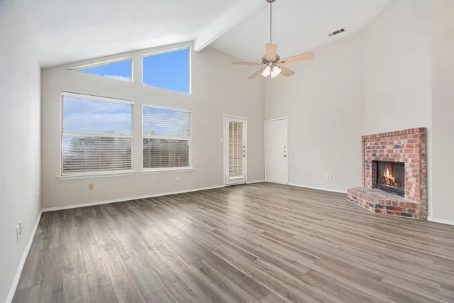 a view of livingroom with window hardwood floor and a ceiling fan