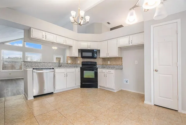 a open kitchen with cabinets a sink and stainless steel appliances