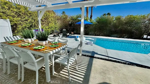 a view of a chairs and table in the patio