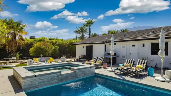 a view of a patio with swimming pool table and chairs
