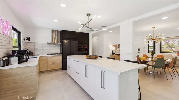 a large kitchen with kitchen island a sink counter space and stainless steel appliances