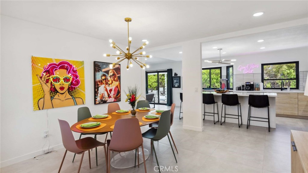 2004 East Nicola Road Palm Springs, CA 92262 - Photo 18 of 40 a view of a dining room with furniture and chandelier