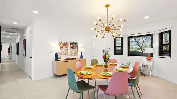 a dining room with furniture a chandelier and a rug