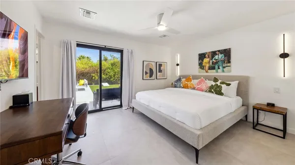 a bed room with a bed and a tv