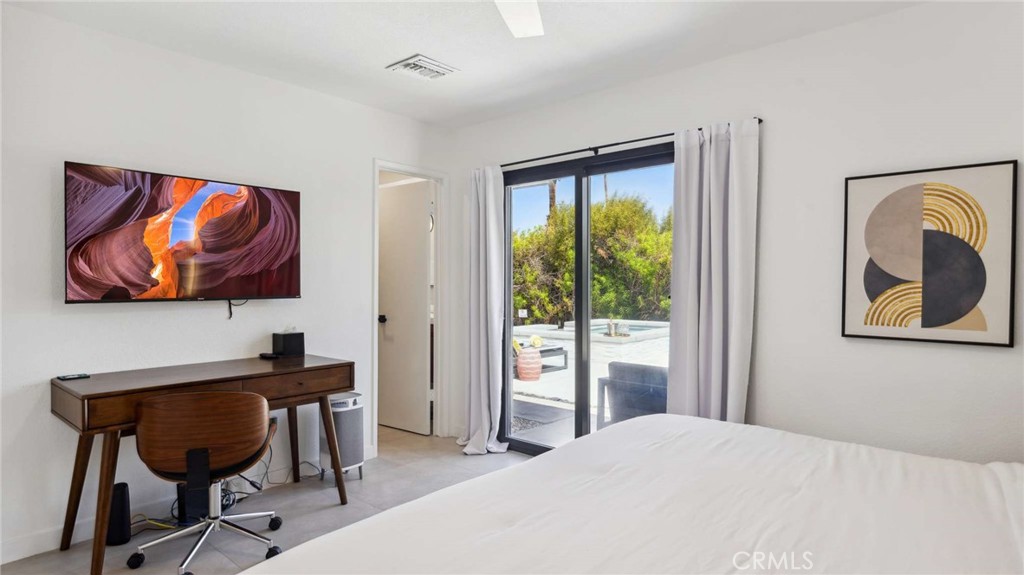 2004 East Nicola Road Palm Springs, CA 92262 - Photo 23 of 40 a bedroom with a bed and a painting on the wall