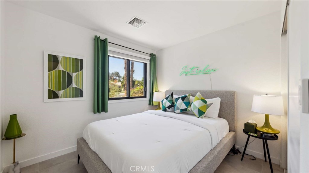 2004 East Nicola Road Palm Springs, CA 92262 - Photo 28 of 40 a bedroom with a bed and a window