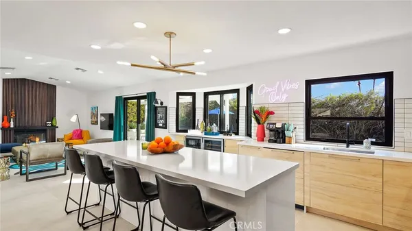 a kitchen with a sink dining table and chairs