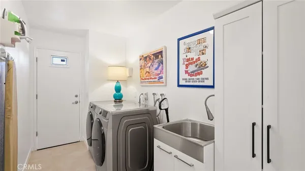 a view of a storage & utility room with two washing machine
