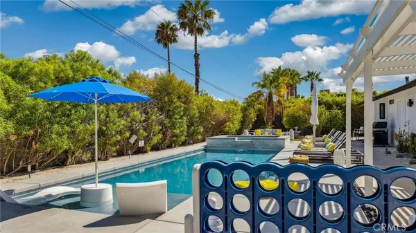 a view of a patio with swimming pool table and chairs